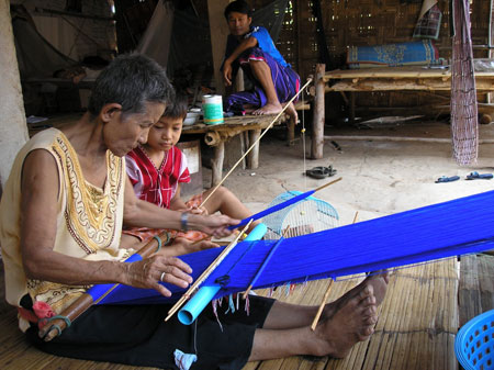 woman teaching a child how to weave